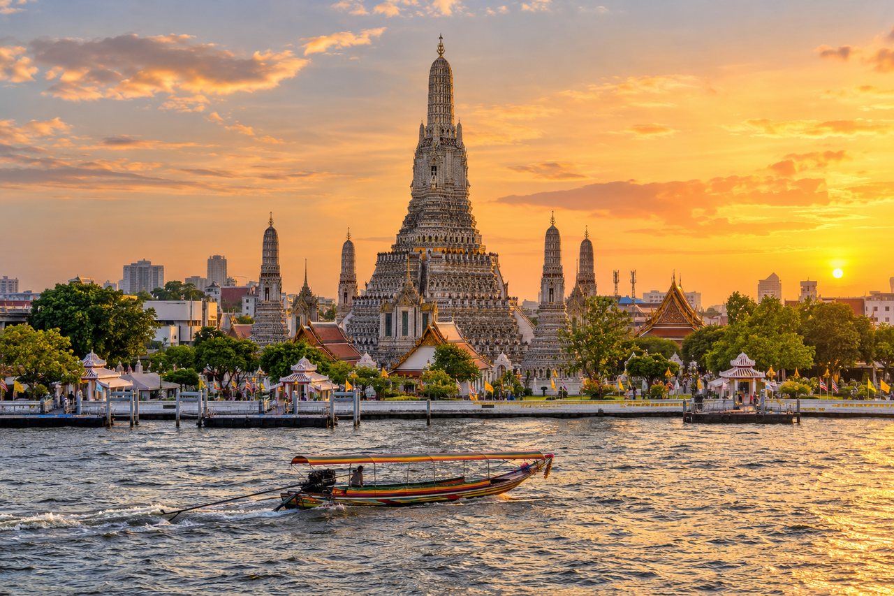 Bangkok: Wat Arun temple on the Chao Phraya River at golden hour with a long-tail boat on the water (AI-generated image)