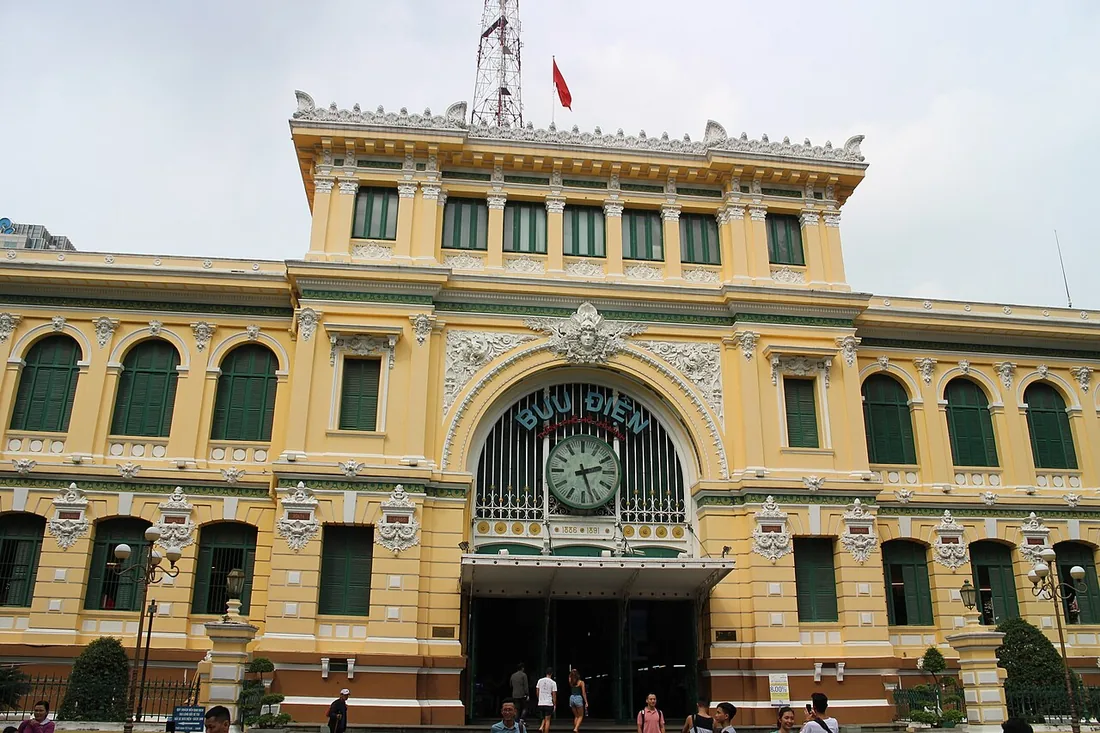 The yellow facade and arched entrance of the Central Post Office in Ho Chi Minh City.